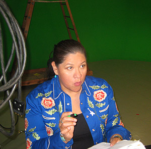 Arigon Starr rehearses with a script in her hand.
